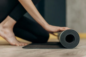 Picture of woman rolling yoga mat