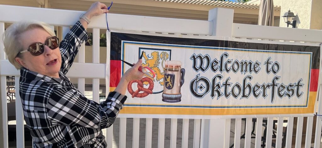 Glen Arden resident Kathy Pope hanging the Oktoberfest welcome sign.