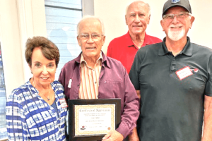 VMA President Karen Kosmala presents medical appointment driver, Victor Clifford, a Certificate of Outstanding Volunteerism. Also pictured are VMA Equipment Delivery and Appointment Managers Gary Walden and Dennis Balanesi.