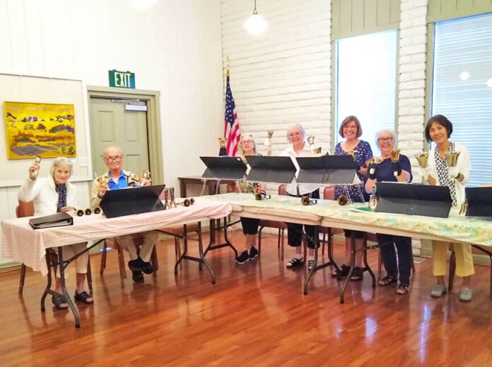 Village Voices members ringing handbells.