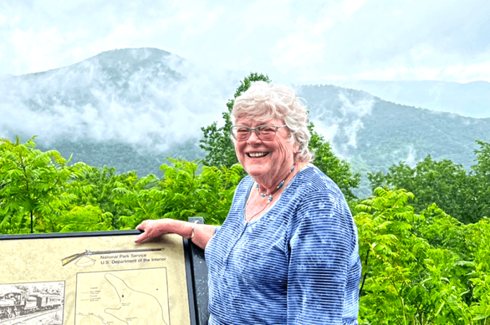 Sara English in front of the Blue Ridge Mountains.