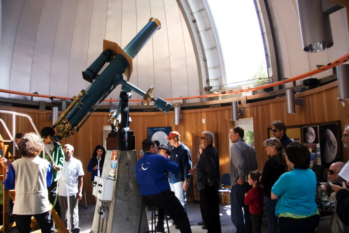 People looking through the telescope at Chabot Center