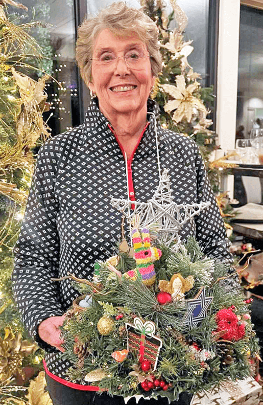 Glen Arden resident Linda Webb holding a dining table centerpiece.