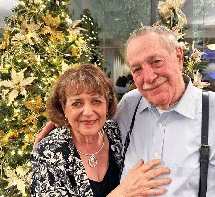 Glen Arden residents, Larry and Kathy Lohman, by the Christmas Tree.