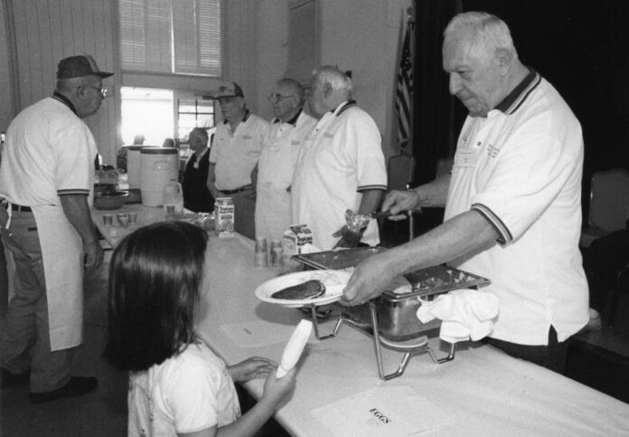 High 12 members serving pancakes in 2005.