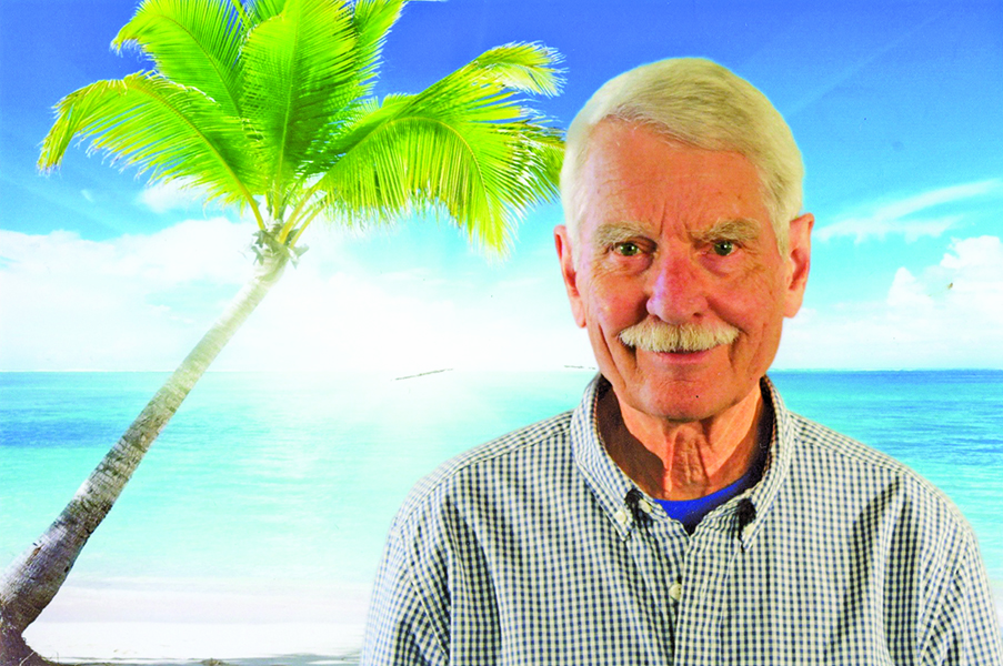 John Eige in front of tropical background