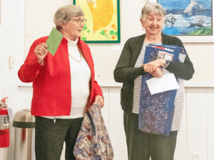 Nancy Chesterton and Loraine Navone prepare to present Quilts of Valor to Villages veterans.