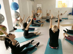 A class of people on yoga mats doing Nirvana Fitness