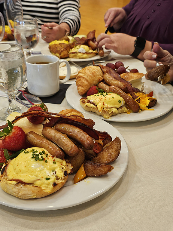 Eggs Benedict, scrambled eggs, potatoes, sausage bacon, croissants, French toast, fresh fruit.