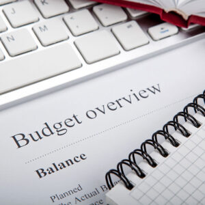 budget overview sheet laying on keyboard